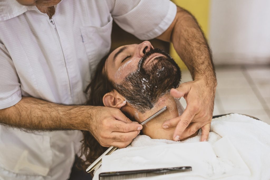 man getting shaved with razor